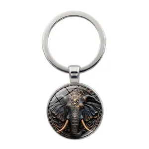 Vintage elephant charm keychain with ornate metal ring and glass dome pendant for bags