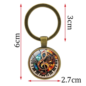 Porte-clés piano bronze avec pendentif en verre et symboles musicaux pour mélomanes