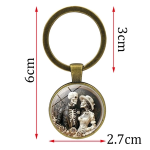 Vintage bronze skull couple glass dome keychain with 6cm length and 3cm ring diameter