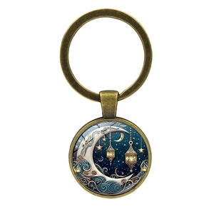 Detailed macro view of antique bronze sun moon goddess glass pendant keychain