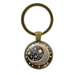 Detailed close-up of a bronze sun and moon goddess glass cabochon keychain charm
