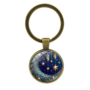 Detailed view of bronze moon and stars glass cabochon keychain for bags and keys