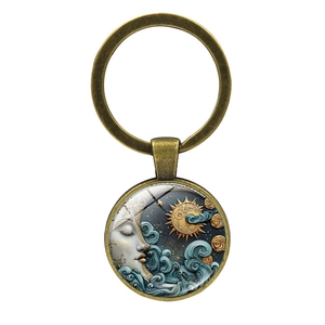 Detail of antique bronze keychain featuring a sun and moon goddess glass cabochon