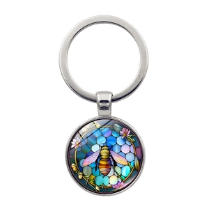 Close-up of bee glass pendant keychain with colorful stained glass art pattern
