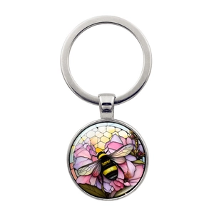 Artistic bee and flower glass cabochon keychain with a polished silver metal ring