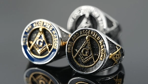 Macro view of Masonic rings showing stainless steel polishing and blue enamel details