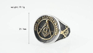 Macro detail of silver and gold Freemason signet ring with engraved emblems and text