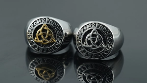 Detailed macro view of Viking rune rings with silver and gold Celtic knot centerpieces