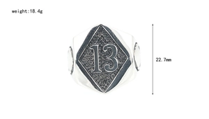 Macro detail of vintage skull ring featuring number 13 on diamond-shaped metal face