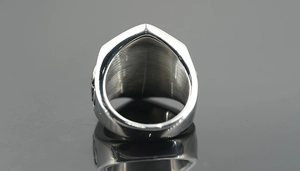 Macro detail of the brushed stainless steel inner surface on a wide punk skull ring