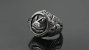 Macro detail of vintage titanium steel ring featuring Horus Eye and honeycomb texture
