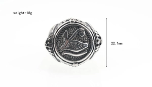 Macro view of men's evil eye ring featuring oxidized finish and embossed details