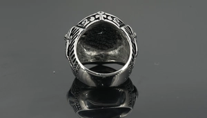 Macro detail of retro punk titanium steel ring with engraved Ankh and wing patterns