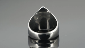 Macro shot of silver titanium steel viking ring showing inner band detail and polished finish