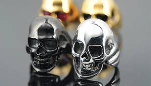 Macro detail of gothic skull rings in polished silver and black steel finishes