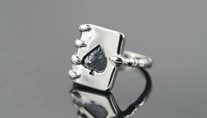 Macro shot of retro spade ace ring with gothic eagle claw and vintage silver finish
