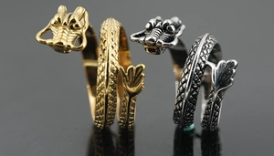 Macro view of gold and silver dragon rings with detailed scales and vintage punk style