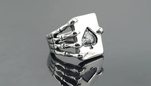 Detailed close-up of retro titanium steel ring featuring skull hand holding Ace of Spades
