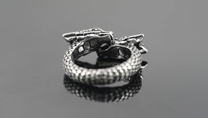 Macro shot of double dragon head vintage titanium steel ring with scaled texture