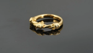 Detail of vintage gold braided texture on a retro titanium steel ring for men and women