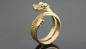 Macro shot of gold dragon-shaped ring featuring detailed scales and vintage punk style