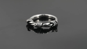 Close-up of vintage titanium steel ring with twisted rope design and oxidised finish