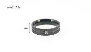 Detail of 4mm black frosted titanium steel ring with polished groove and round zircon
