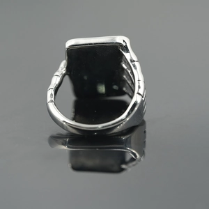 Polished silver stainless steel ring with flat rectangular top and bone texture details