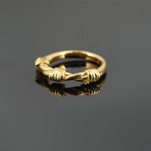 Polished gold titanium steel ring featuring a vintage twisted wire design on black background