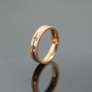 Rose gold titanium steel ring with frosted finish and sparkling center stone inlay