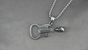Macro detail of vintage silver guitar pendant with skull design and bottle opener function