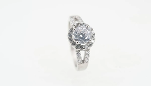 Macro side view of silver titanium steel halo ring with split-shank and sparkling zircons