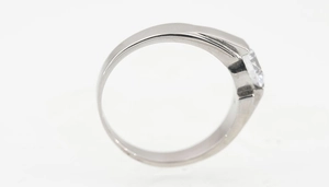 Zijaanzicht van een minimalistische zilveren titanium ring met gepolijste band en één diamant