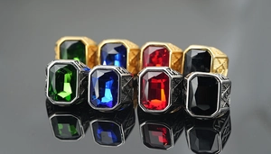 Macro detail of Masonic rings with colorful gemstones and vintage steel engravings