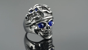 Macro shot of punk skull ring in titanium steel featuring striking blue zircon eyes