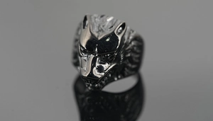 Detailed view of an intricate wolf head ring with a vintage dark gray metallic finish