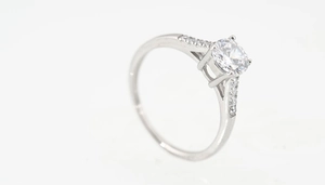 Detail view of titanium steel ring featuring four-prong set round cut diamond solitaire