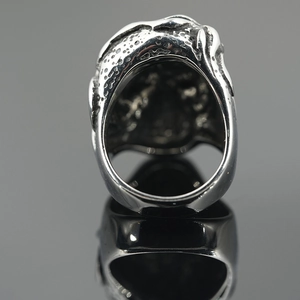 Gothic skull ring with green eyes in antique silver finish featuring a bold punk design