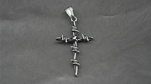 Macro shot of vintage silver cross pendant with realistic barbed wire wrap detailing