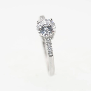 Classic silver titanium steel ring with a round centerpiece diamond and small side stones