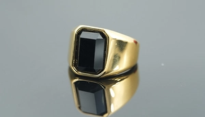 Polished gold signet ring for men featuring a rectangular black onyx gemstone inlay