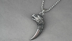 Vue macro détaillée d'un pendentif tête de loup gravé avec finition argentée vintage et chaîne