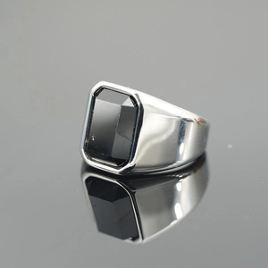 Polished silver ring for men with a large rectangular black onyx gemstone on mirror surface