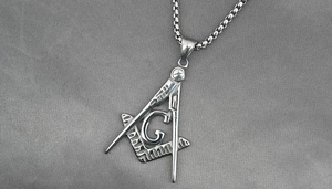Detailed close-up of a silver Masonic square and compass pendant with G on a box chain