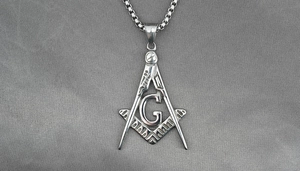 Detail showing the Freemasonry square and compass pendant with G letter in silver steel