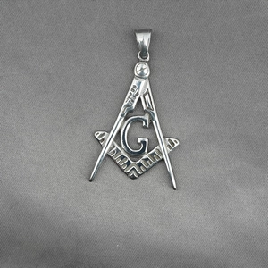 Silver Freemasonry compass and square pendant necklace with G symbol on grey fabric