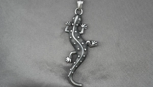 Macro view of lizard pendant in vintage silver steel with detailed textured skin finish