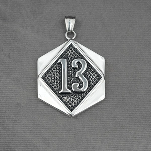 Industrial vintage titanium steel hexagon pendant with number 13 relief on gray fabric