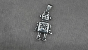 Detailed view of a vintage silver astronaut pendant with an industrial finish and antennas