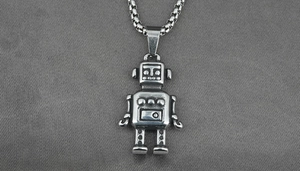Macro shot of retro silver astronaut pendant with distressed finish on a square box chain